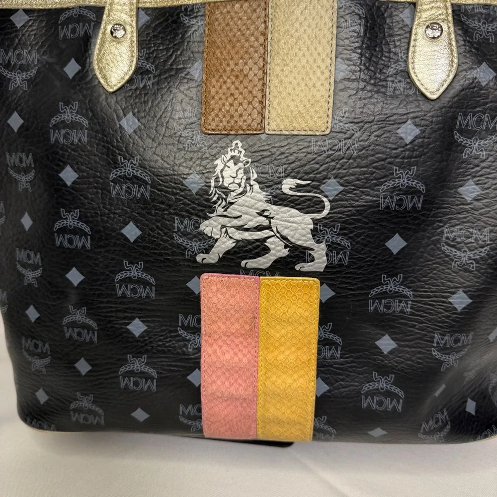 MCM Visetos Monogram Medium Tote Bag Black Gold‎ Lion Graphic Striped